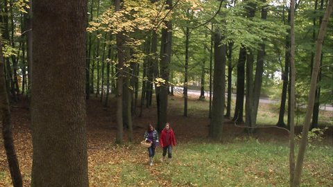 Mother and daughter walking in a forest