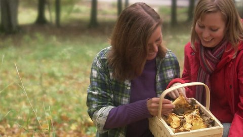 Mother and daughter picking mushrooms