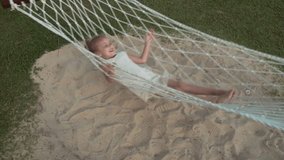 Happy little girl swinging in the hammock slow motion stock footage video