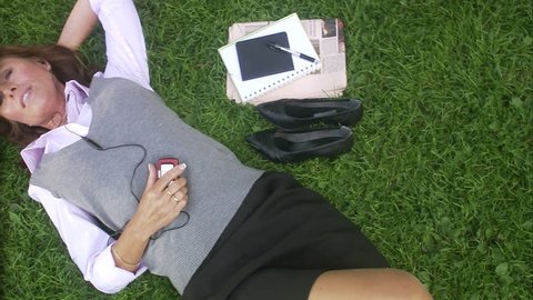 A woman in a park using her mobile phone