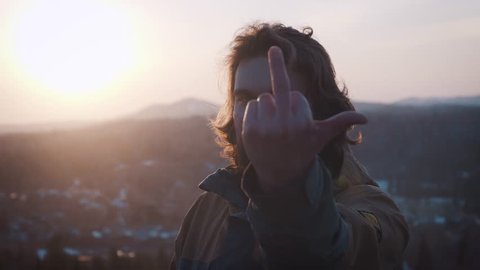 Man Showing Fuck You Against the sunset