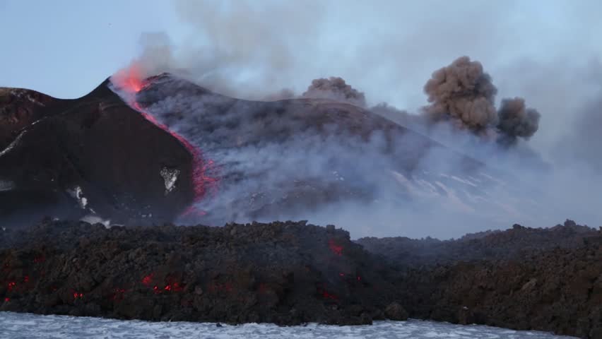Mount Etna erupts at sunset in Sicily 