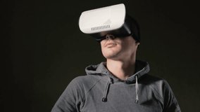 Man wearing virtual reality headset at living room.
