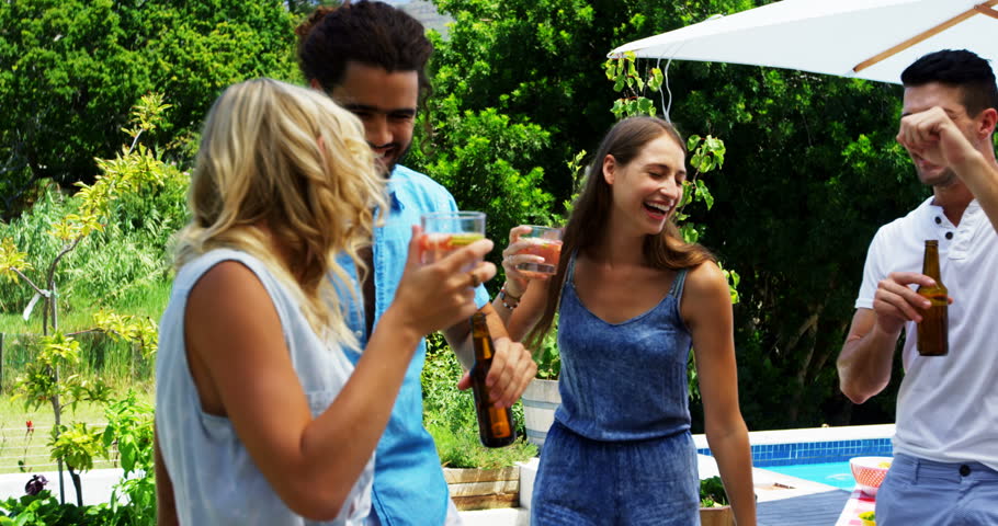 Happy family doing water gun battle in swimming pool