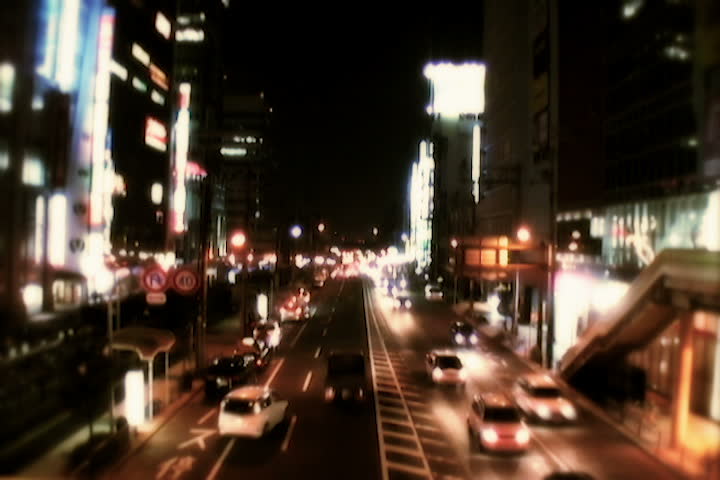 A busy street at nighttime with soft glow