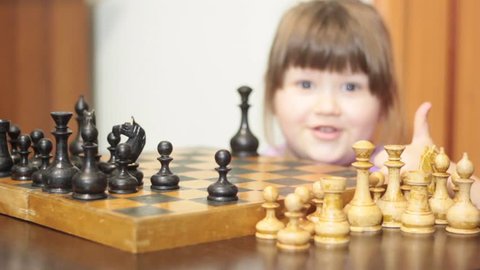LITTLE GIRL PLAYS PUTS A CHECKMATE IN A CHESS GAME