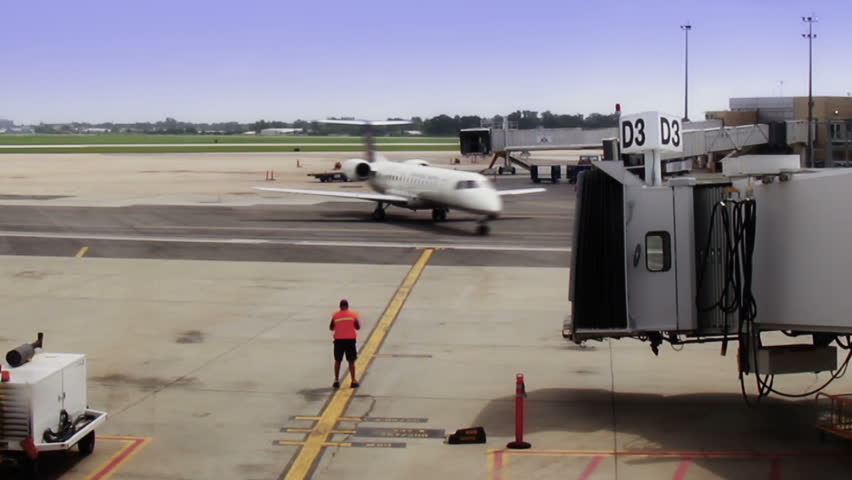 Time lapse shot of a plane arriving at the gate.