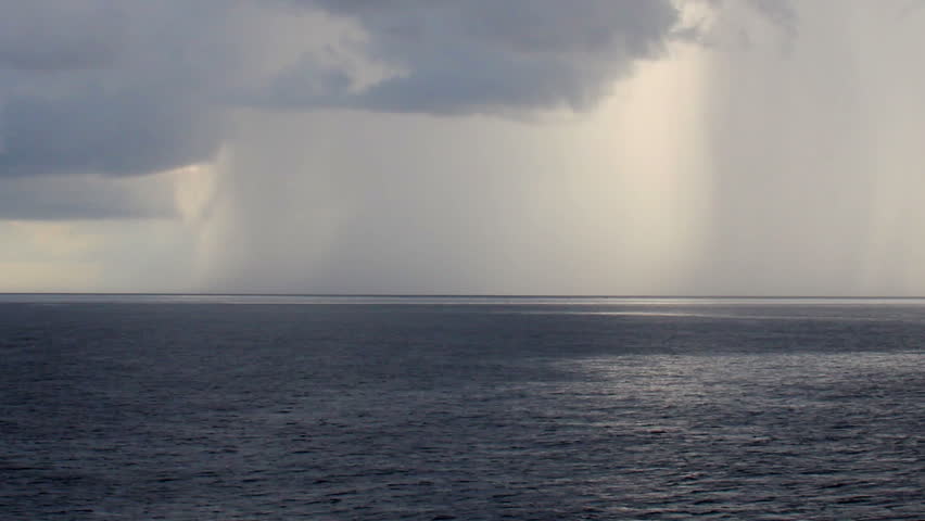 A storm in the distance over the ocean.
