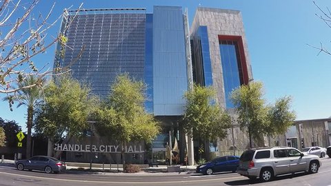 CHANDLER AZ/USA: March 23, 2017- Pan tilting shot of the City Hall building in Chandler Arizona. A wide slow motion  view reveals city offices and municipal facilities as well as sign with town name.