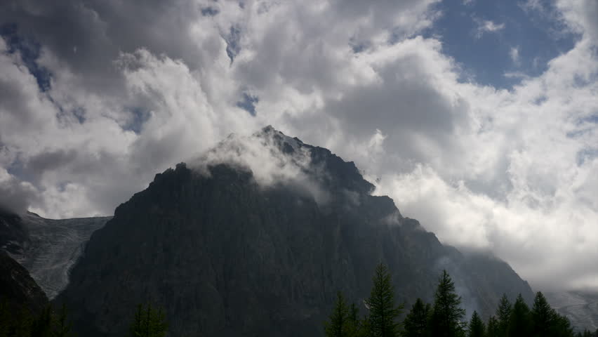 stock video footage mountain landscape, scenery, view, scene, paysage clouds hovering around the top of the mountain