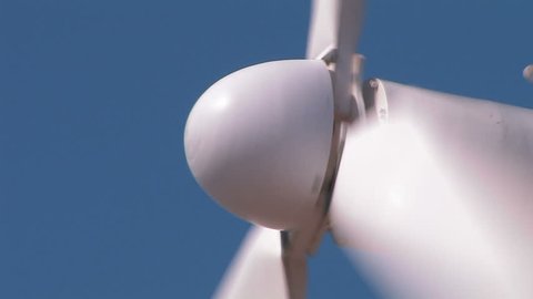 Wind turbine against clear blue sky. Close-up.