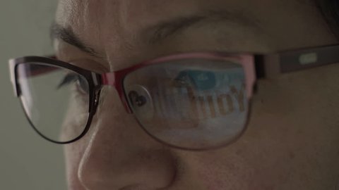 HALLE, GERMANY - APRIL 25, 2017: Reflection of Youtube Logo in the lens of the glasses of a middle age woman.