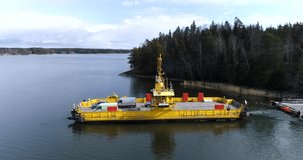 Skåldö cable ferry, Cinema 4k aerial view of a sideway flight following a yellow cable ferry, in Skaldo, in the tammisaari archipelago, in Finland