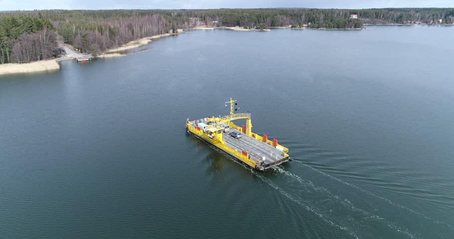 Skåldö cable ferry, Cinema 4k aerial 90 degree orbit view following of a yellow cable ferry, in Skaldo, in the tammisaari archipelago, in Finland