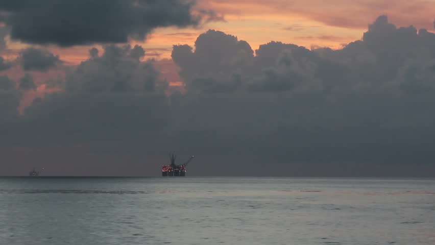 An oil rig in the distance in the Gulf of Mexico.