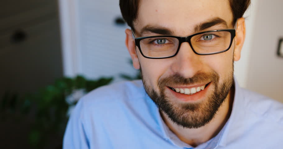 Young man posing on camera. Business man smiling. Close up. Top view.