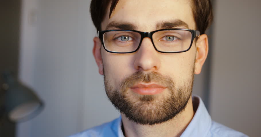 Portrait of successful businessman smiling on camera at  office. Close up . Slow Motion RED EPIC