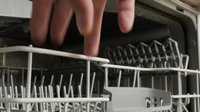 Modern dishwasher racks sliding close-up 4K 2160p 30fps UltraHD footage - Dishware and cutlery washing machine trays 3840X2160 UHD video