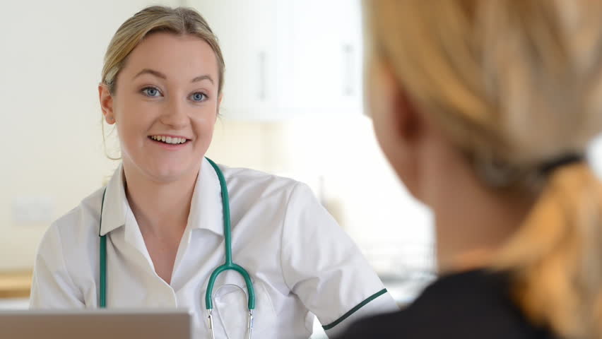 Woman meeting with female doctor in surgery who gives her prescription form Royalty-Free Stock Footage #26237207
