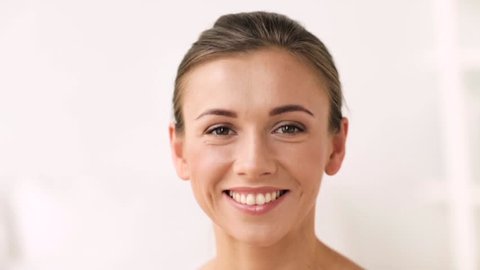 beauty and people concept - face of happy smiling young woman