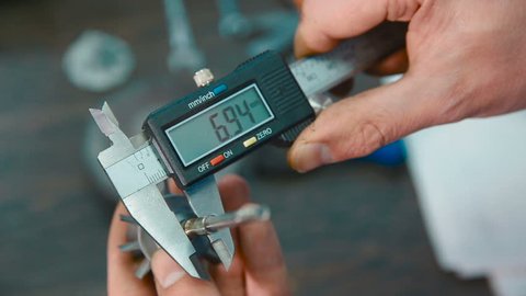 Industrial worker measure detail with digital caliper