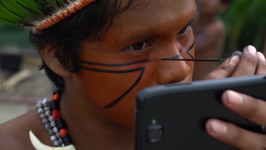 Native Brazilian Man (Indio) Painting on his Face in a Indigenous Tribe