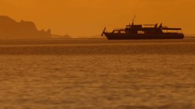 Silhouette of tourist cruiser at sunset 