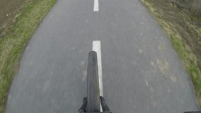 Cycling. Shot on the front wheel while riding. Stabilized video.