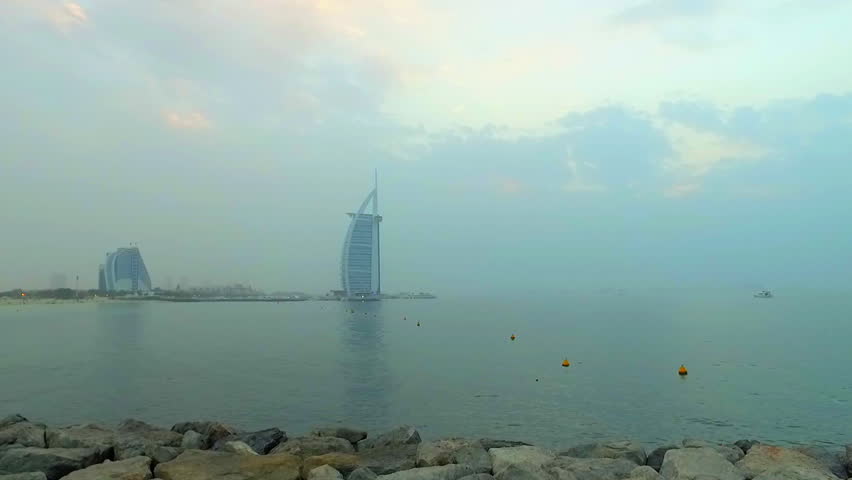 Dubai, United Arab Emirates HD video from stone beach and Persian Gulf water. High-tech architecture building and travel real estate cityscape