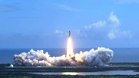 Space shuttle lifting off over the water. Rocket launch.