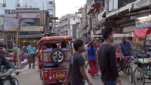 INDIA - CIRCA JUNE 2016 - Busy crowded narrow street, bicycle rickshaws, cars, people, Main Bazar, Delhi