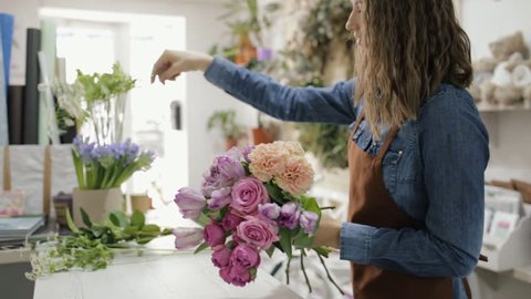 Florist woman make a bouquet of beautiful flowers