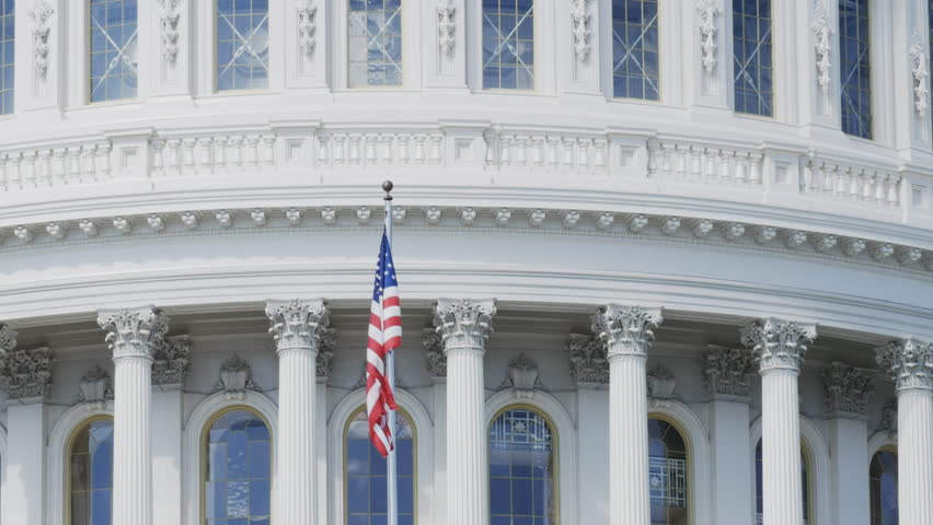 Close up of the stars and stripes flag on west side of the the capitol building in Washington D.C.