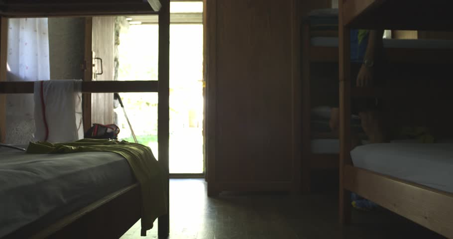 caucasian trail runner getting ready to go out running in mountain through woods, villages. 4k gimbal wide back video shot