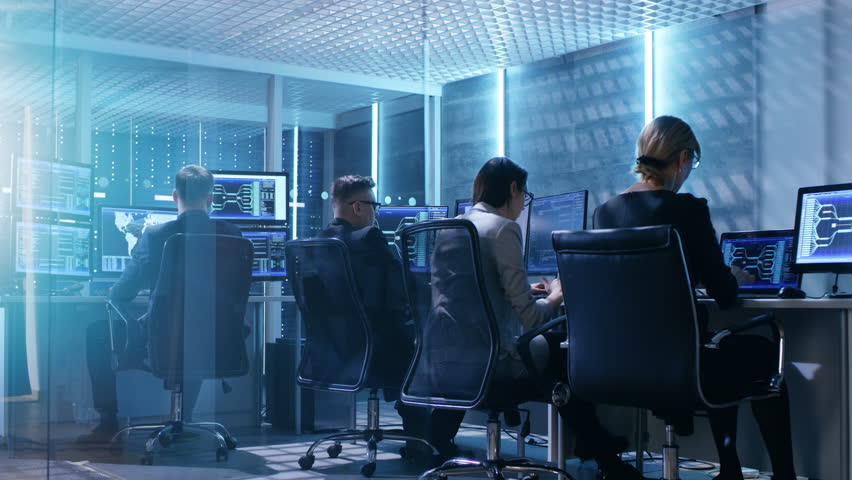 Time-Lapse Footage of Government System Control Center Full of Proffesional. They Work at Their Workstations and Interact With Each Other. Room Has Multiple Displays with Various Data Shown on Screens