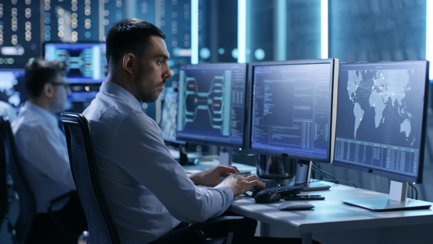 In the Monitoring Room Team of System Engineers Working at Their Workstations. Multiple Displays Show Various Important Data and Information. Possible Air Traffic/ Power Plant/ Security Room Theme.  | Shutterstock HD Video #26262980