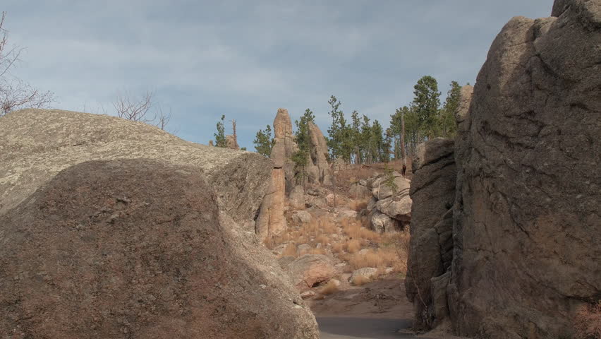 FPV, CLOSE UP: Driving on scenic steep curvy mountain pass road on Needles Highway, South Dakota. Stunning scenery of eroded granite pillars, spires and rock formations in Black Hills National Forest