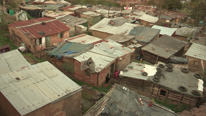 Informal settlements close together in Durban, people going  in and out of their