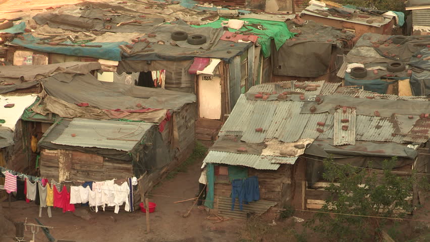 Informal settlements close together in Durban, people going  in and out of their