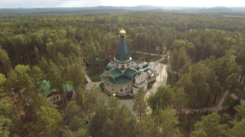 Religion Ganina Yama Romanov family Tsar Nicholas II mine near Yekaterinburg Russia. Monastery church complex golden domes. Forest beautiful nature. Sunny day. Helicopter aerial drone flight above. 