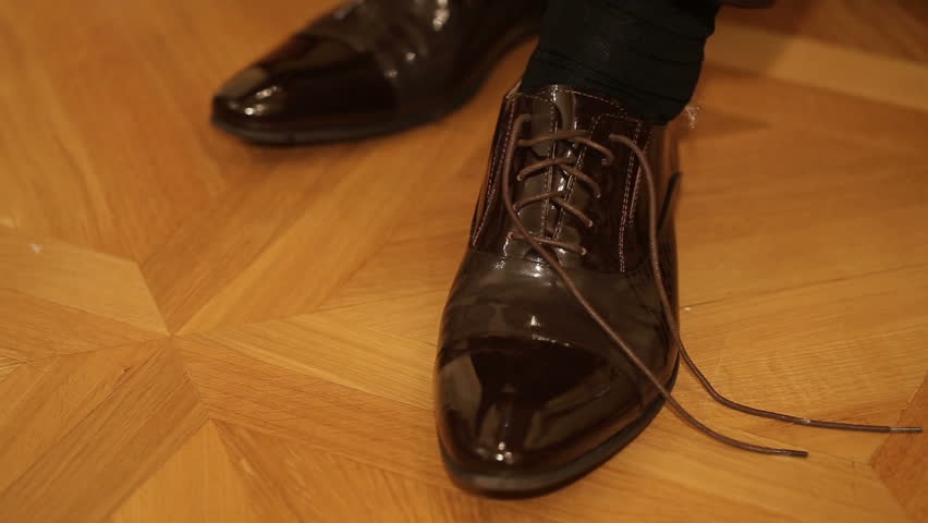 This is his shoes. Black man tieing Shoe Lace.