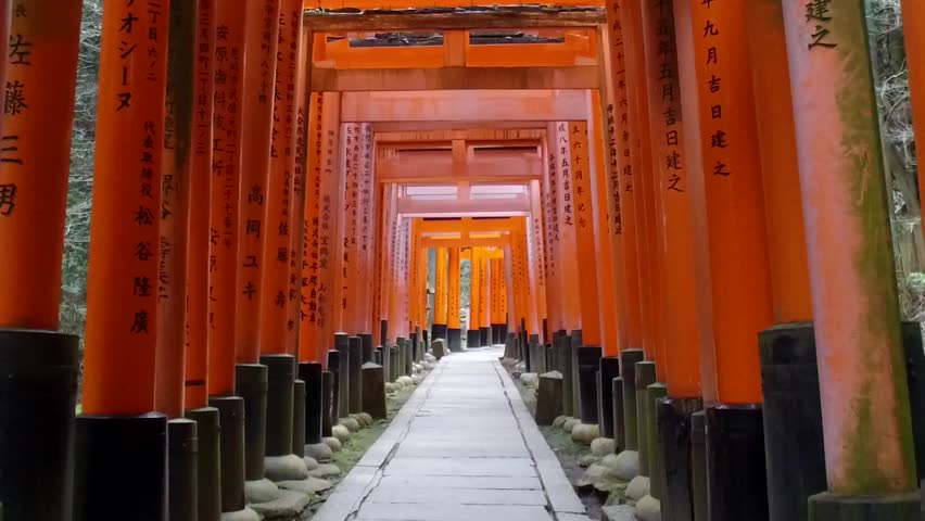 POV SLOW MOTION: Walking inside Fushimi Inari Shrine or Fushimi Inari Taisha, a Shinto shrine in Kyoto, Japan. A Japanese monument, famous for its thousands of vermilion torii gates. Royalty-Free Stock Footage #26278748