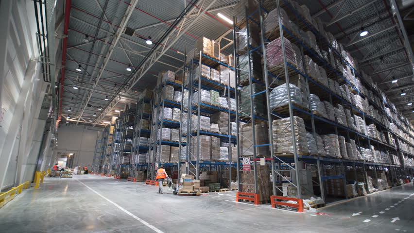 Industrial warehouse with boxes. Forklift Small cargo truck drives to warehouse. Large warehouse logistics terminal. Person worker walking in big storehouse. Interior mail Industry. Wide shot 4k | Shutterstock HD Video #26284268