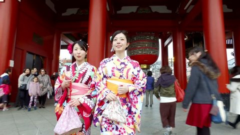 TOKYO, JAPAN - CIRCA MARCH, 2017: Women wearing traditional kimono walking in Senso Ji Temple. The Senso-ji Temple is the symbol of Asakusa and one of the most famous temples in Japan. 