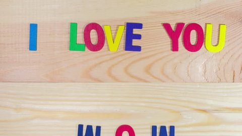stop motion animation colorful wooden letter " I love you MOM" on wooden background in concept happy mother's day