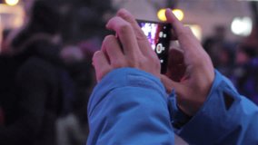 night shooting mobile phone/young man shoots video on smartphone