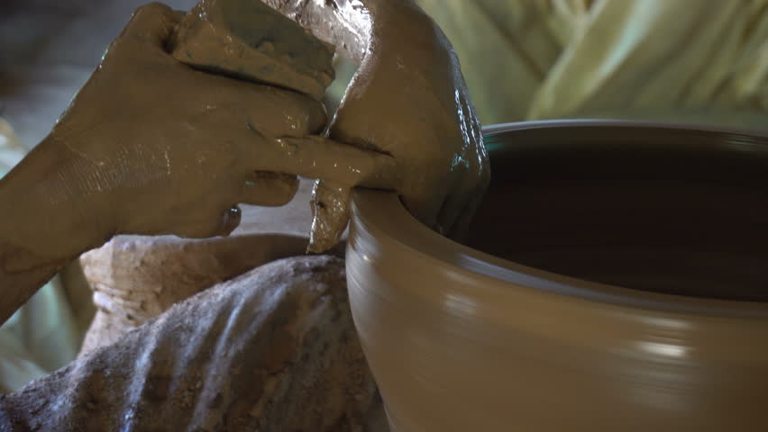 Close up of man making pot on pottery wheel in traditional style at thailand