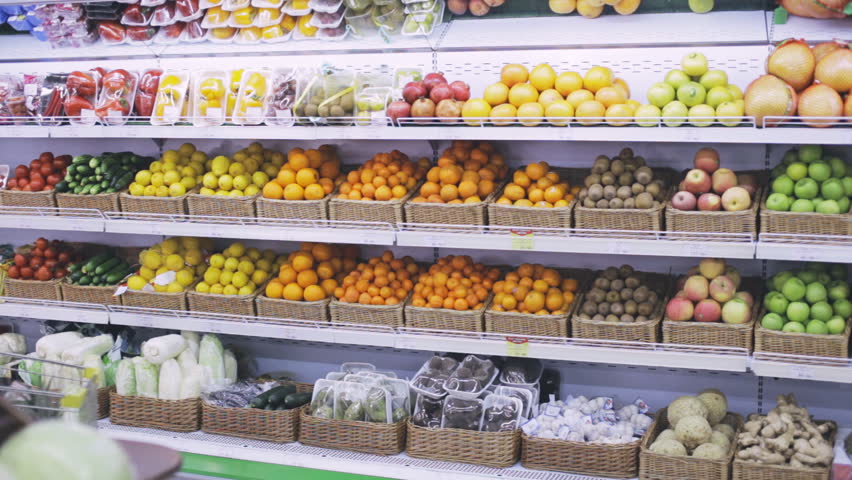 Young woman chooses fruits in the supermarket Royalty-Free Stock Footage #26305397