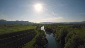 4K AERIAL River calmly moving through the marsh on a sunny day