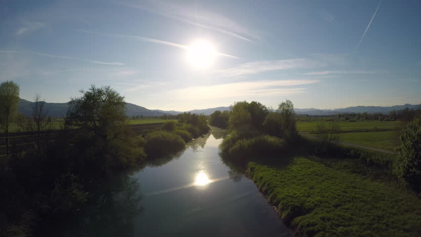 4K AERIAL Sun reflecting on the river surface 